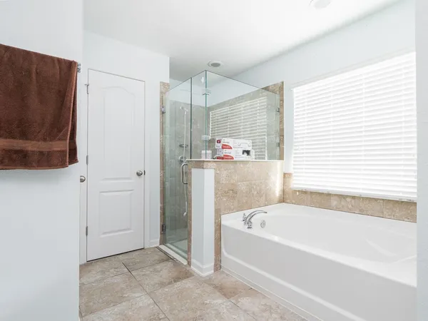 a room with mirror and cabinets