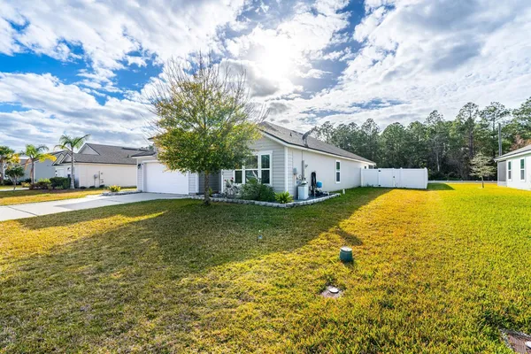 a view of an house with swimming pool and a yard
