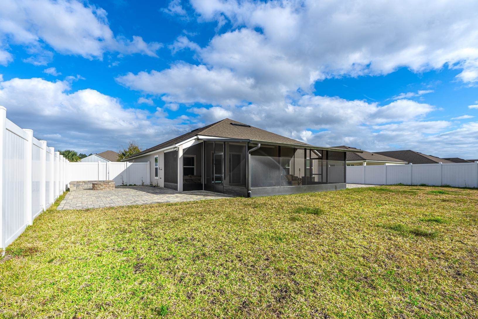 178 South Hamilton Springs Road St. Augustine, FL 32084 - Photo 22 of 26 a yellow house with green field in front of it