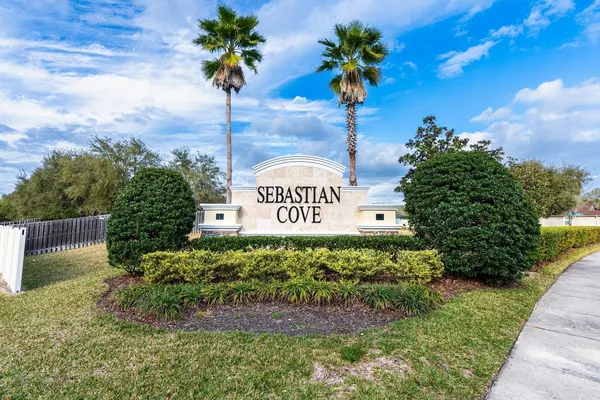 a sign that is sitting on a brick wall