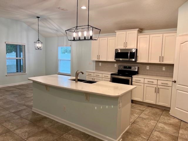 178 South Hamilton Springs Road St. Augustine, FL 32084 - Photo 5 of 26 a kitchen with stainless steel appliances granite countertop a sink a stove oven a counter space and cabinets