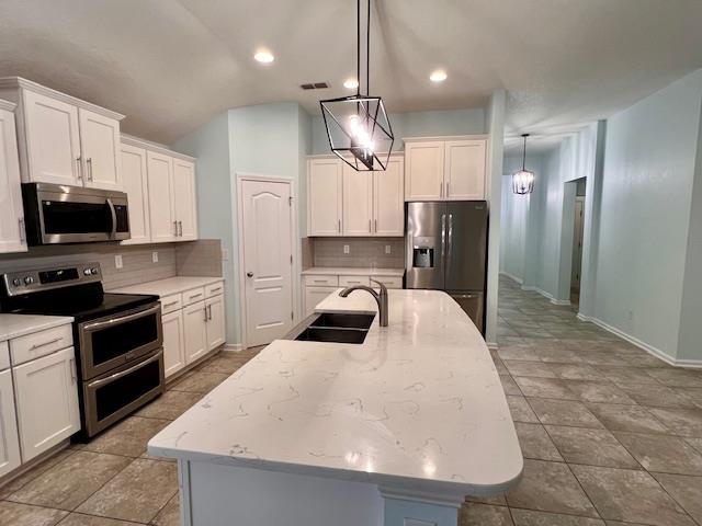 178 South Hamilton Springs Road St. Augustine, FL 32084 - Photo 8 of 26 a kitchen with stainless steel appliances a stove a refrigerator a sink a oven with white cabinets and wooden floor