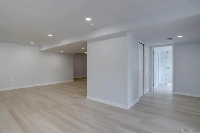 a view of an empty room with wooden floor