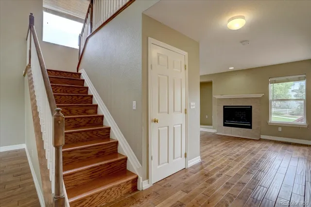 a view of a livingroom with wooden floor and staircase