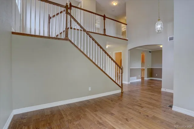 a view of staircase with wooden floor and a window