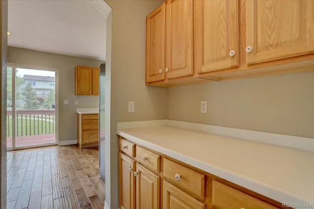a room with a sink cabinets and wooden floor