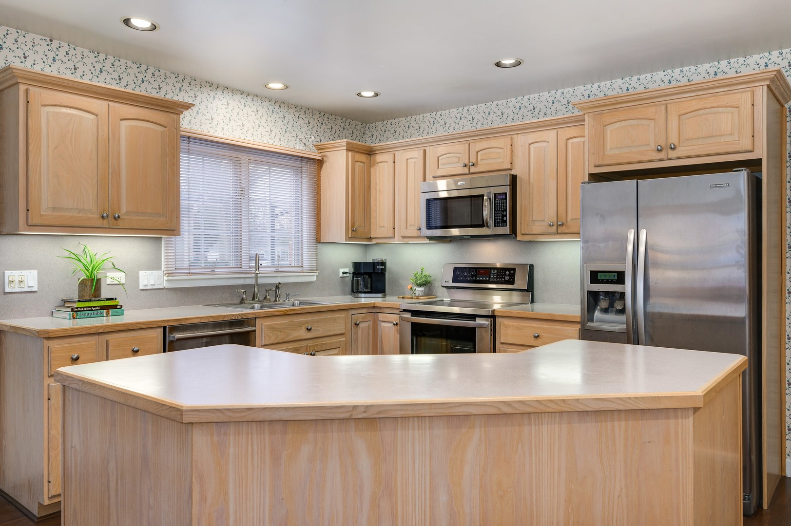 1924 Linneman Street Glenview, IL 60025 - Photo 11 of 24 a kitchen with granite countertop a sink a counter top space stainless steel appliances and cabinets