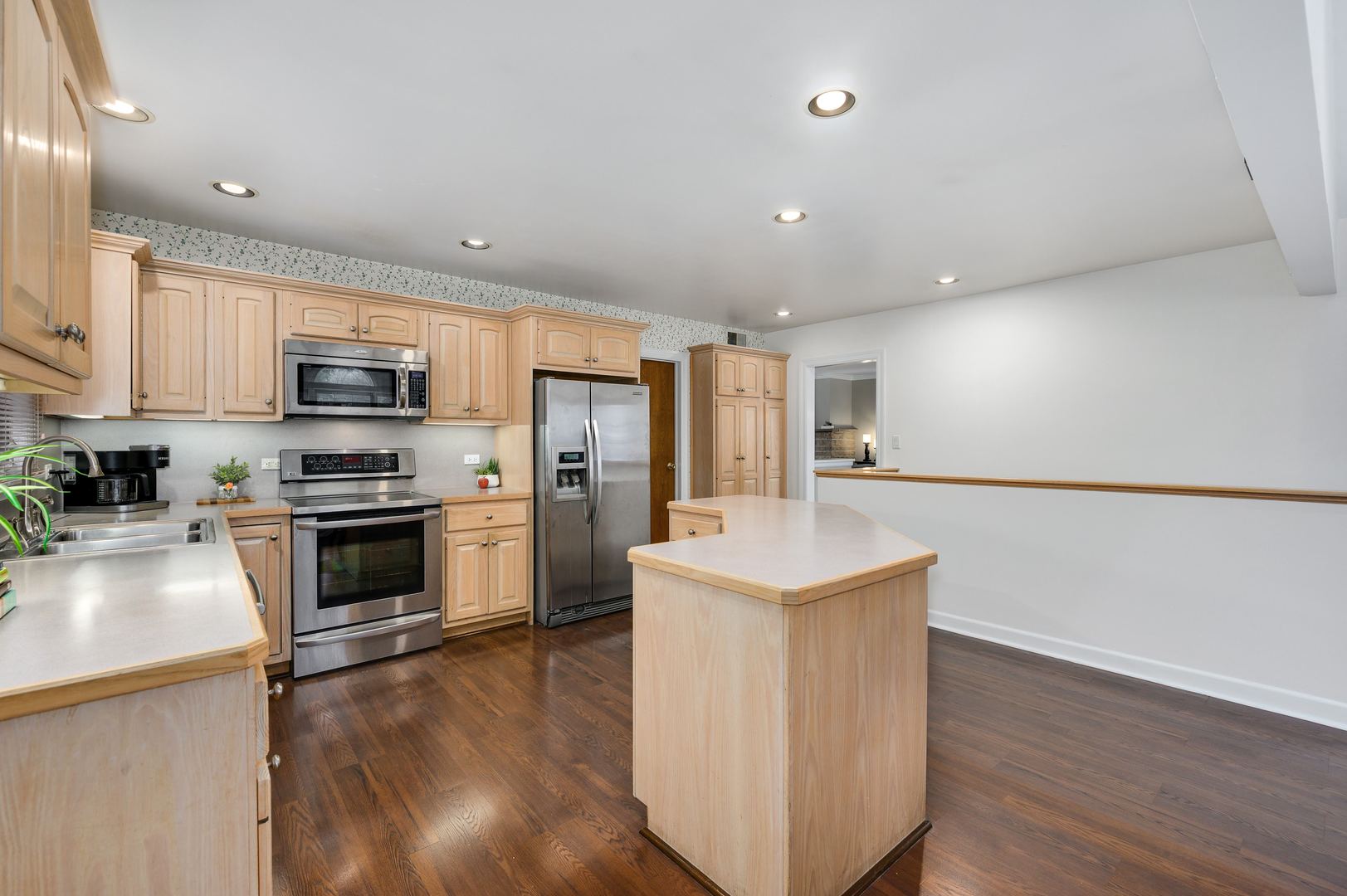 1924 Linneman Street Glenview, IL 60025 - Photo 12 of 24 a kitchen with a sink a counter top space stainless steel appliances and cabinets
