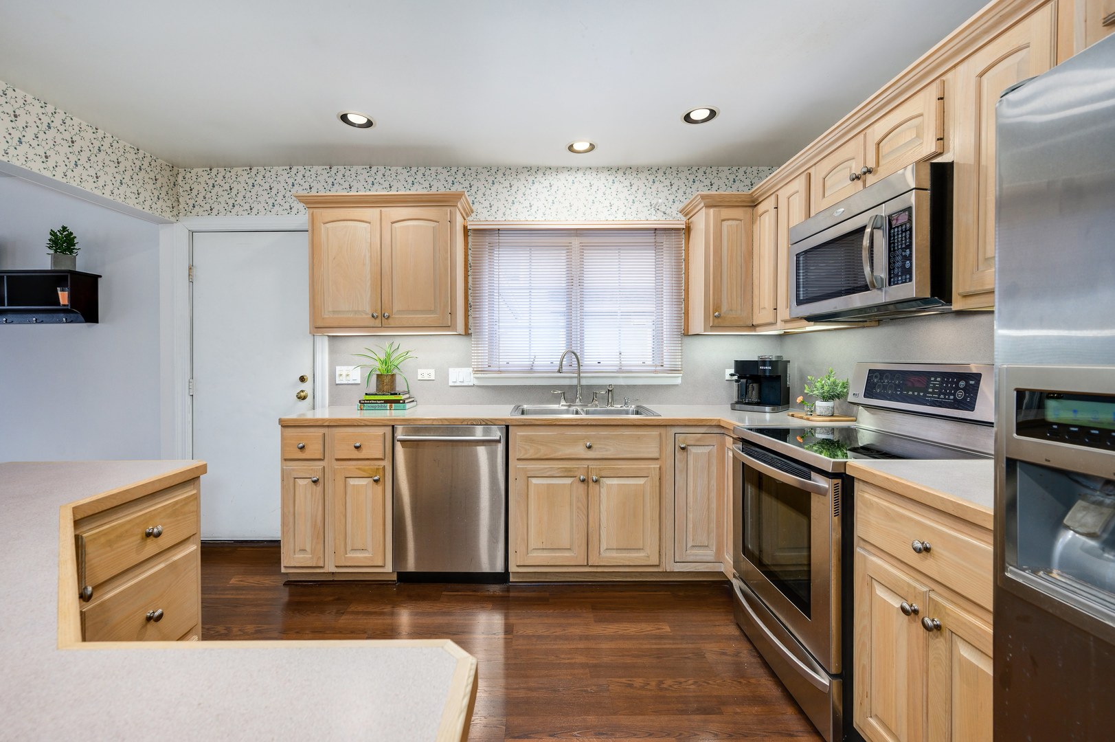 1924 Linneman Street Glenview, IL 60025 - Photo 13 of 24 a kitchen with stainless steel appliances granite countertop a stove a sink and a microwave