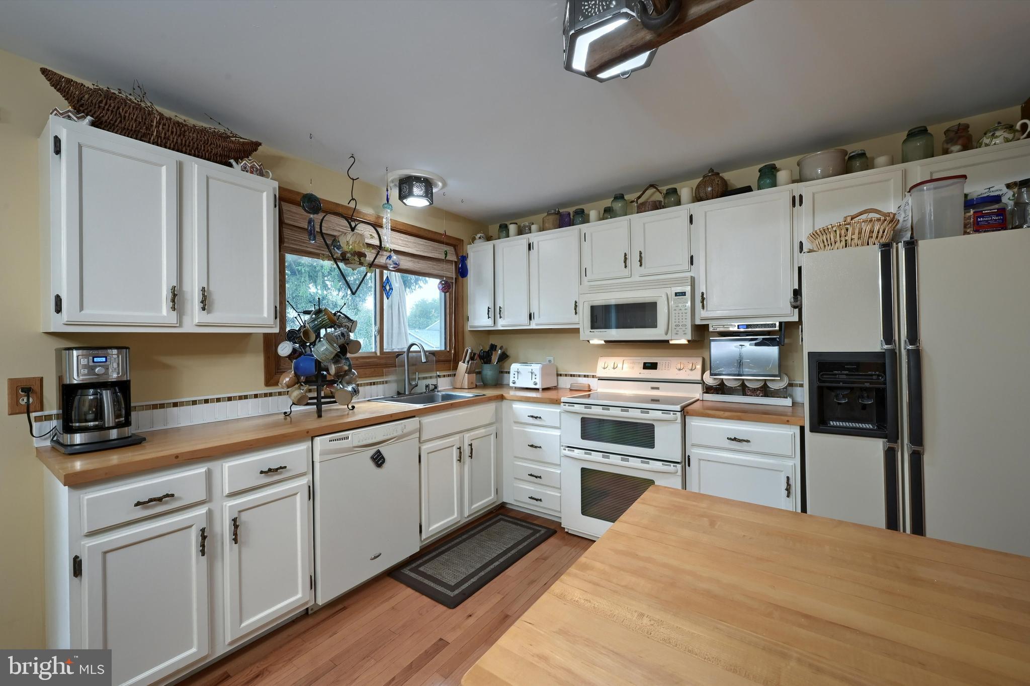 124 Petersburg Road Lancaster, PA 17601 - Photo 5 of 26 a kitchen with white cabinets stainless steel appliances and a window