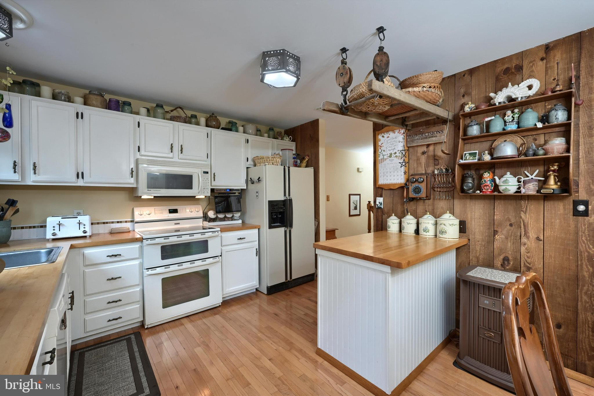 124 Petersburg Road Lancaster, PA 17601 - Photo 8 of 26 a kitchen with stainless steel appliances granite countertop a refrigerator a stove a sink dishwasher and white cabinets with wooden floor