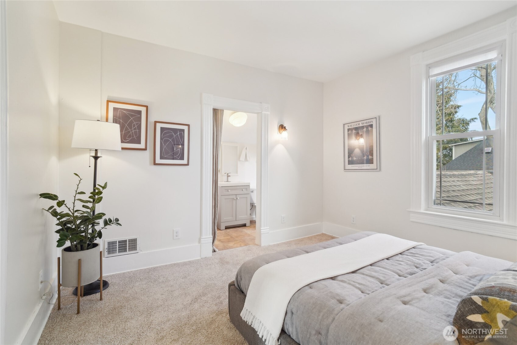 1420 North 50th Street Seattle, WA 98103 - Photo 17 of 30 a bedroom with a bed and a potted plant