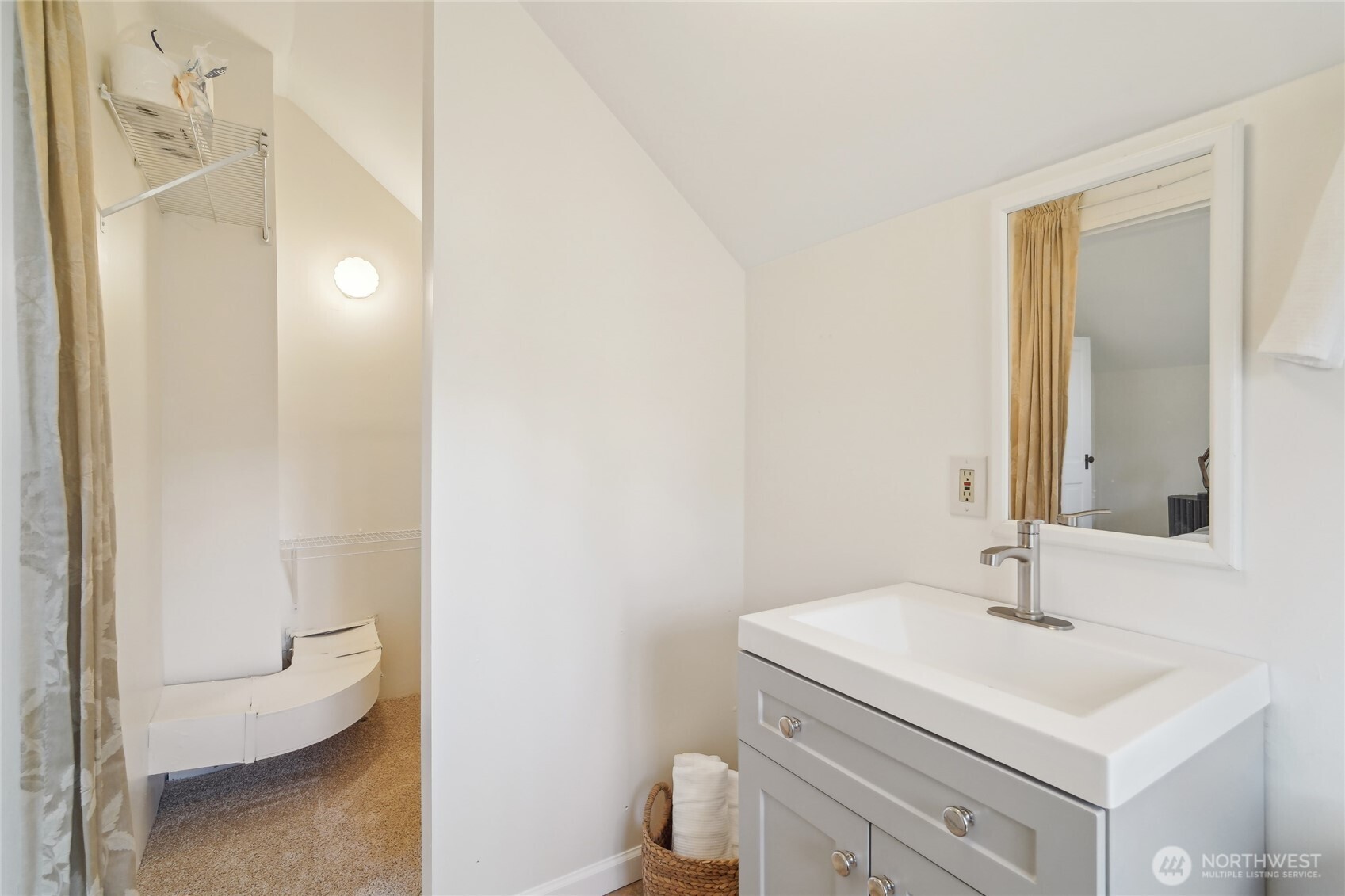 1420 North 50th Street Seattle, WA 98103 - Photo 19 of 30 a bathroom with a sink a toilet and a mirror