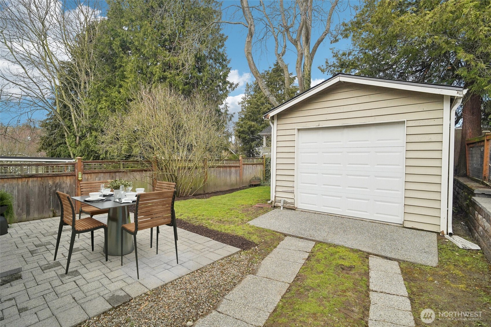 1420 North 50th Street Seattle, WA 98103 - Photo 25 of 30 a backyard of a house with table and chairs