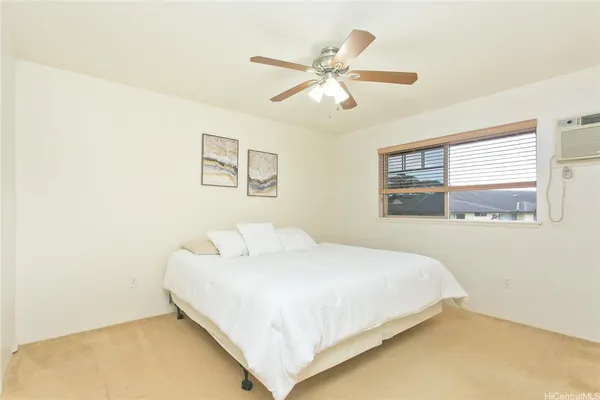 a bedroom with a bed and window