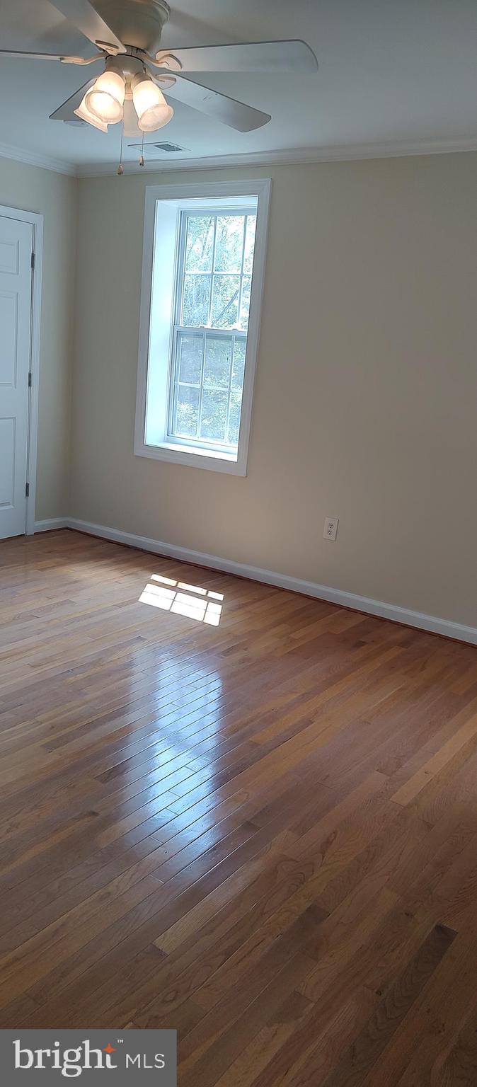 2019 Barclay Street Baltimore, MD 21218 - Photo 11 of 39 an empty room with wooden floor and windows
