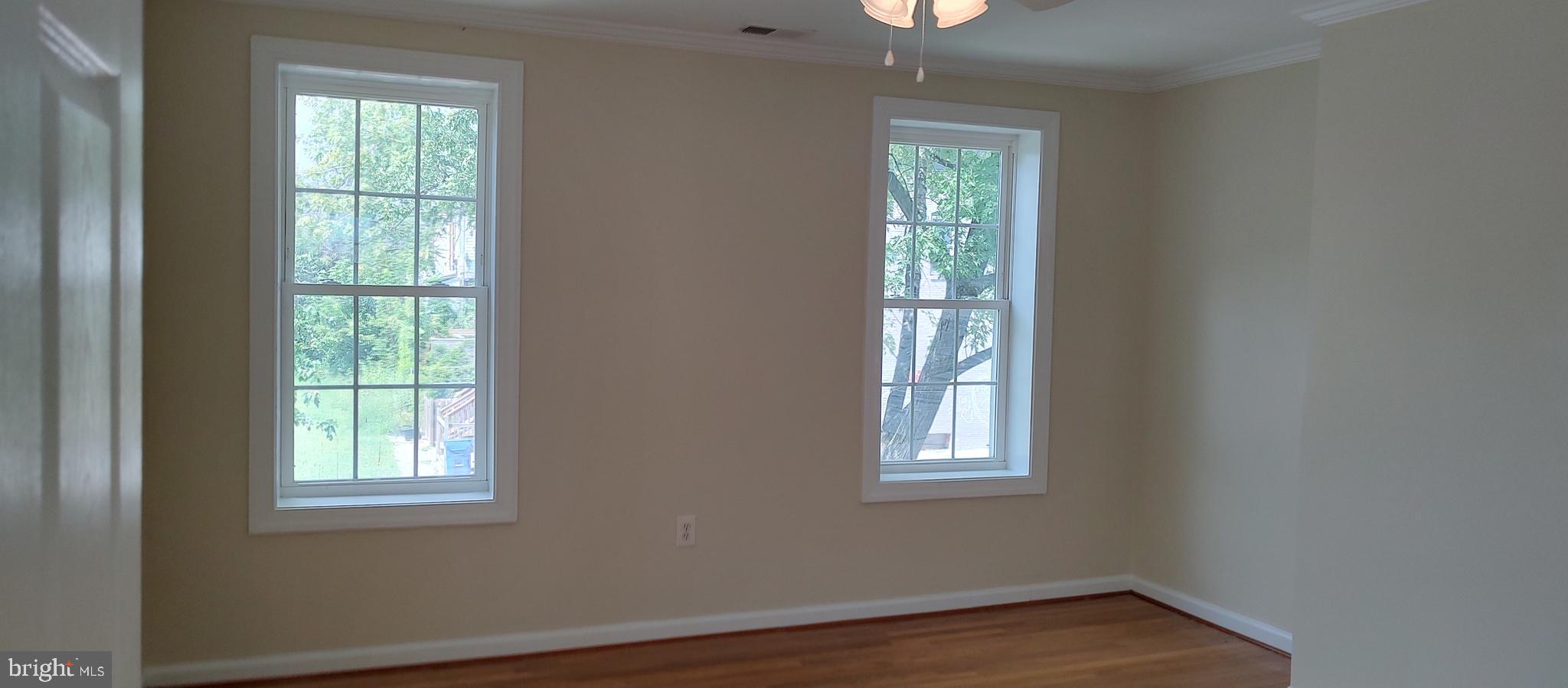 2019 Barclay Street Baltimore, MD 21218 - Photo 14 of 39 a view of an empty room with wooden floor and a window