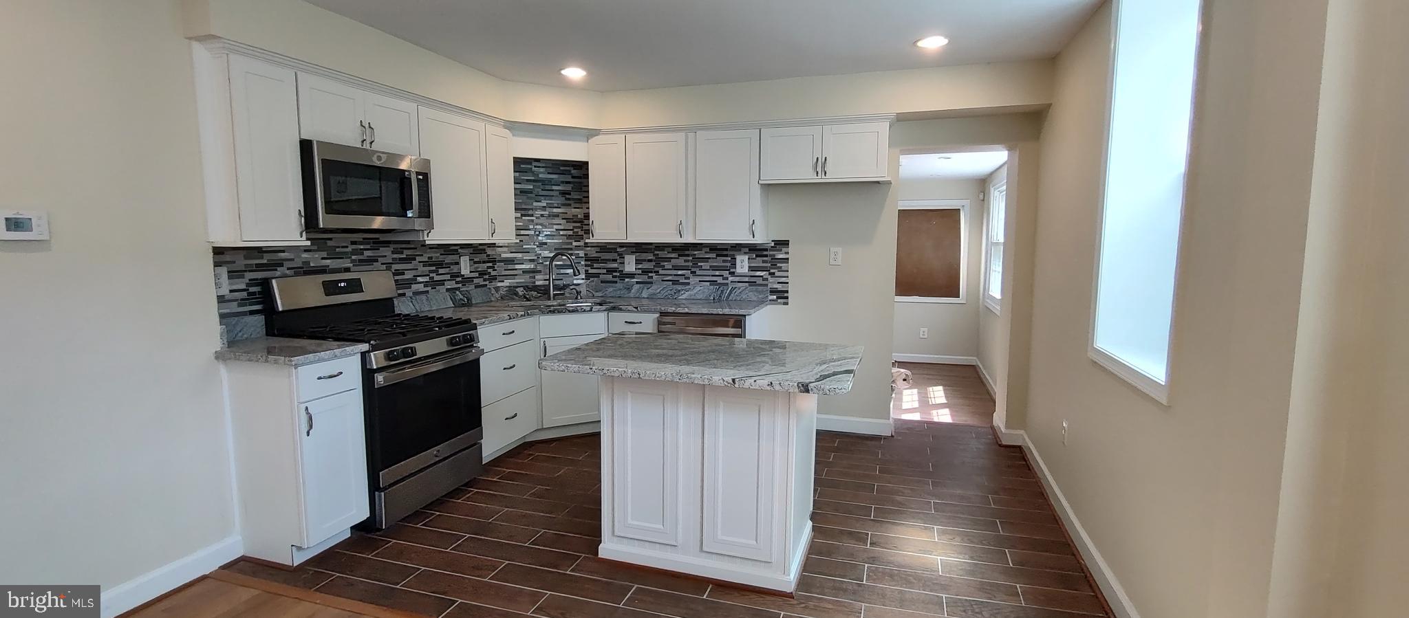 2019 Barclay Street Baltimore, MD 21218 - Photo 3 of 39 a kitchen with stainless steel appliances granite countertop a stove and a sink