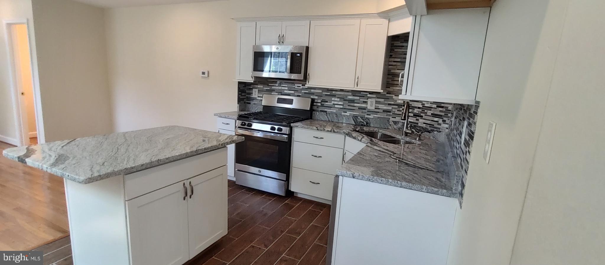 2019 Barclay Street Baltimore, MD 21218 - Photo 4 of 39 a kitchen with stainless steel appliances granite countertop a stove and a sink