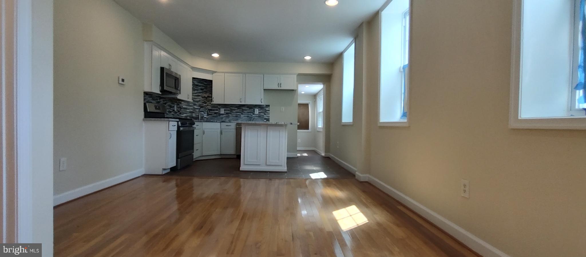 2019 Barclay Street Baltimore, MD 21218 - Photo 5 of 39 a view of a kitchen with a sink and a refrigerator