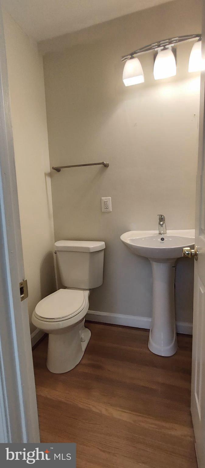 2019 Barclay Street Baltimore, MD 21218 - Photo 6 of 39 a white toilet sitting next to a bathroom sink