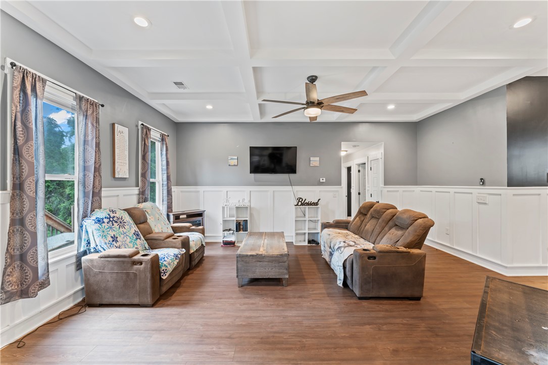 429 Nelson Drive Anderson, SC 29621 - Photo 7 of 32 Coffered ceilings define this inviting living room, offering a sense of grandeur and refined comfort.