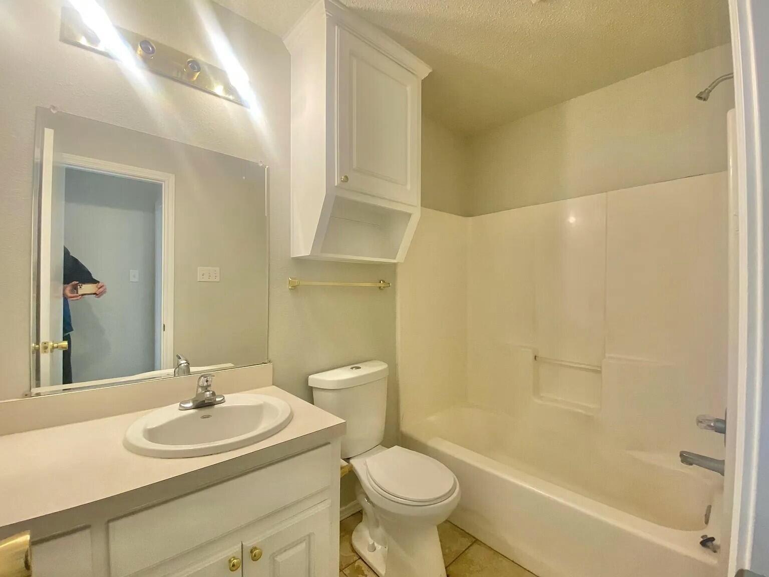 3 St Lubbock Tx 79415 Lubbock, TX 79415 - Photo 17 of 44 a bathroom with a sink and a mirror