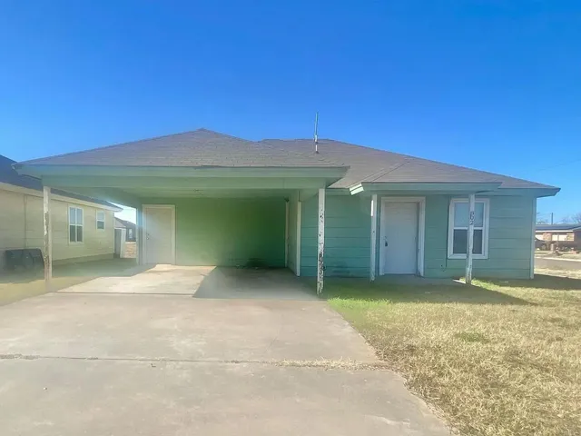 a view of a house with a yard and garage