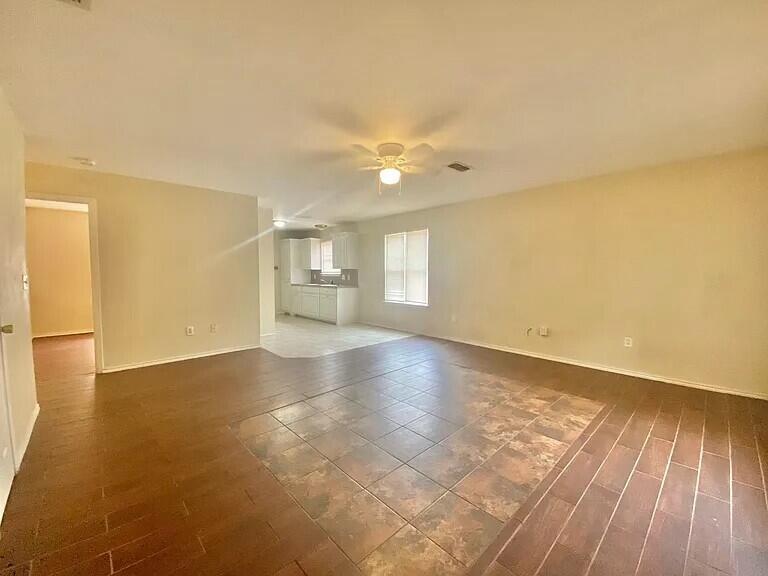 3 St Lubbock Tx 79415 Lubbock, TX 79415 - Photo 35 of 44 an empty room with wooden floor and windows with curtains