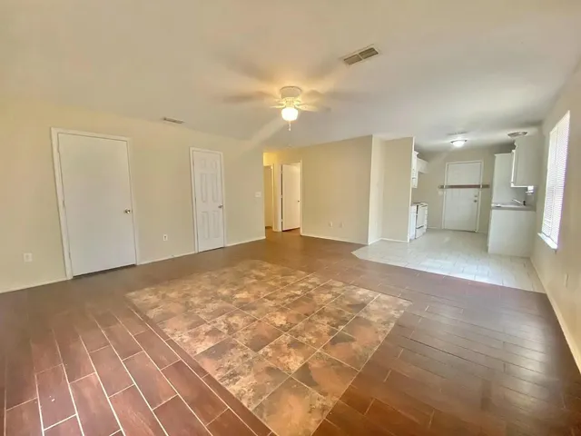 a view of a big room with a kitchen