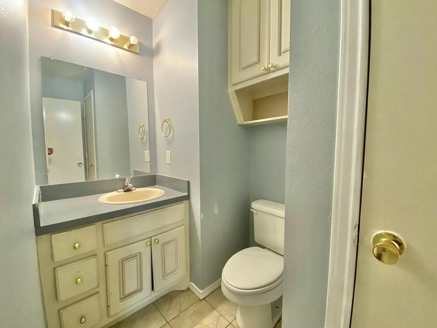 3 St Lubbock Tx 79415 Lubbock, TX 79415 - Photo 9 of 44 a bathroom with a granite countertop toilet sink and mirror