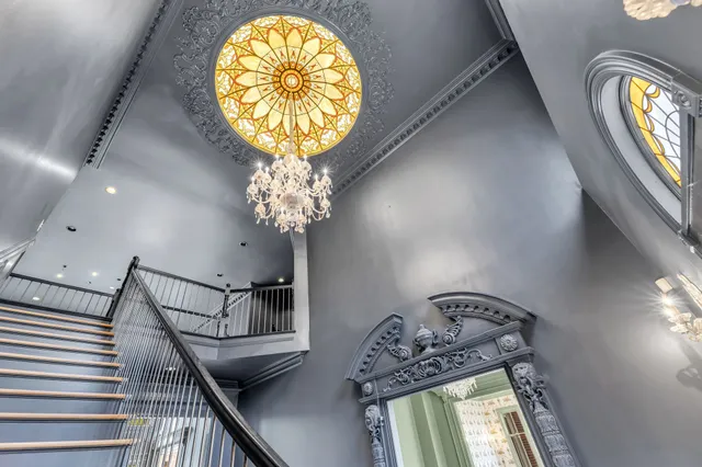 a spacious bathroom with a granite countertop sink a toilet a mirror and shower