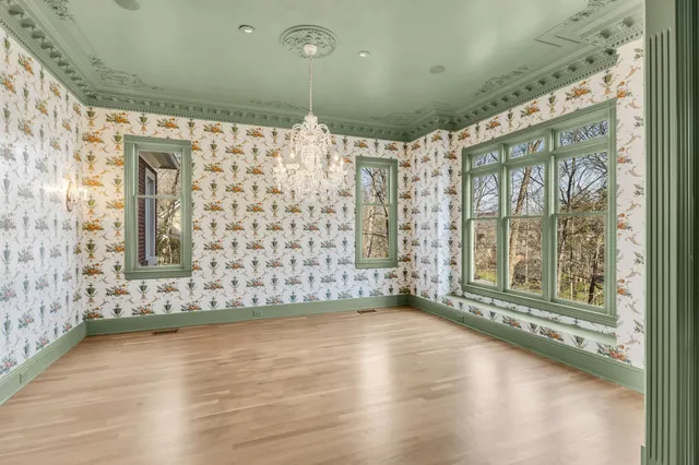 a spacious bathroom with a granite countertop sink a mirror and a shower