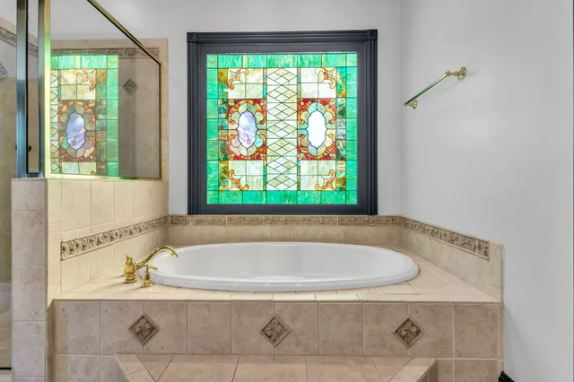 a view of empty room with wooden floor and ceiling fan