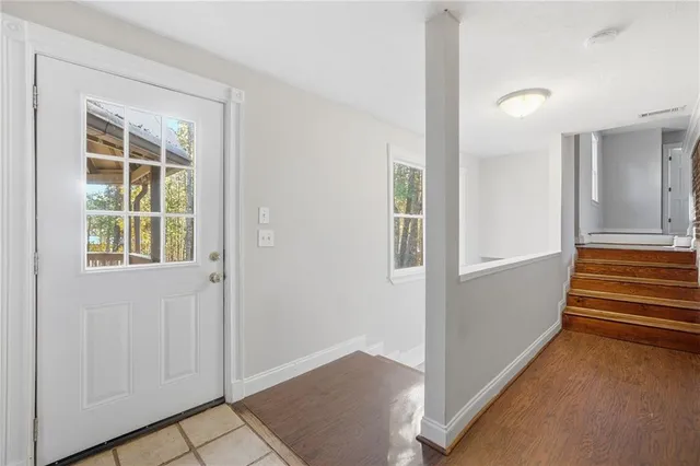 an entryway with a cabinet and a window