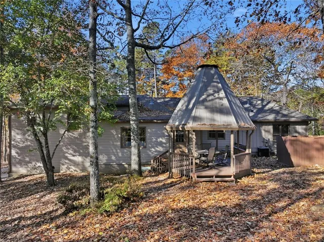 a view of a small house with wooden fence and floor