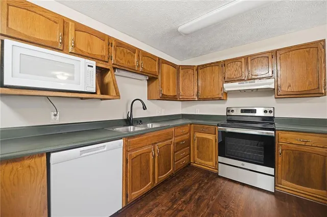 a kitchen with stainless steel appliances granite countertop a sink and cabinets