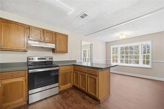 a kitchen with stainless steel appliances granite countertop a stove and a sink