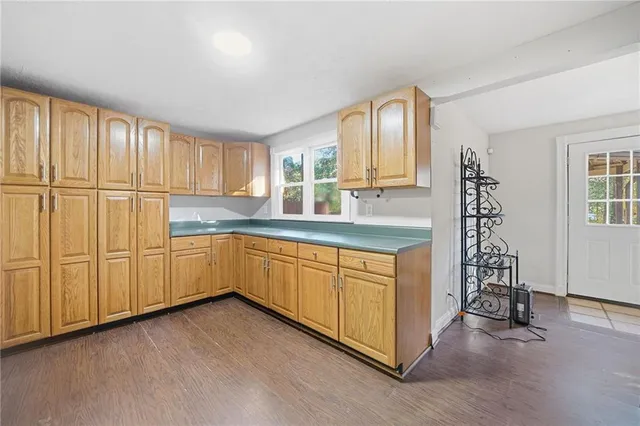 a kitchen with a refrigerator a sink and cabinets