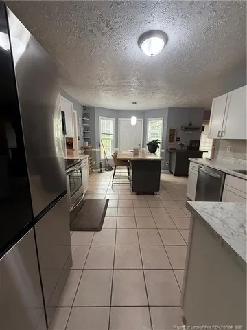 a kitchen with a sink a counter top space and appliances