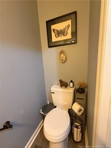 a white toilet sitting next to a small bathroom