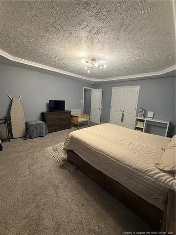 a spacious bedroom with a bed and a chair