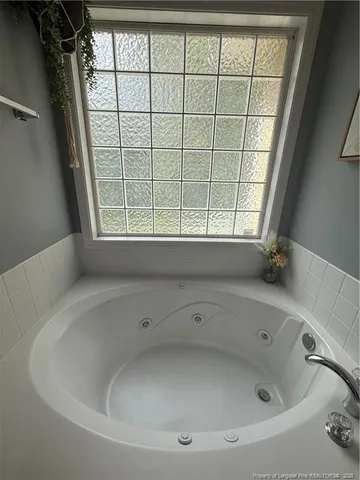 a bathroom with a bathtub and window