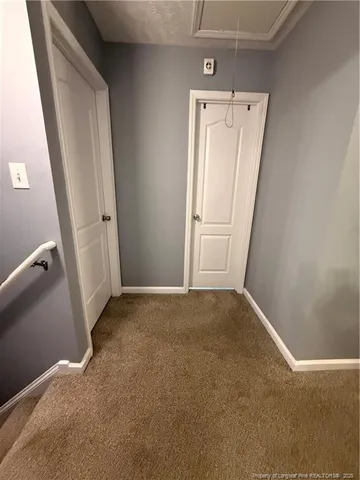 a white toilet sitting next to a white wall