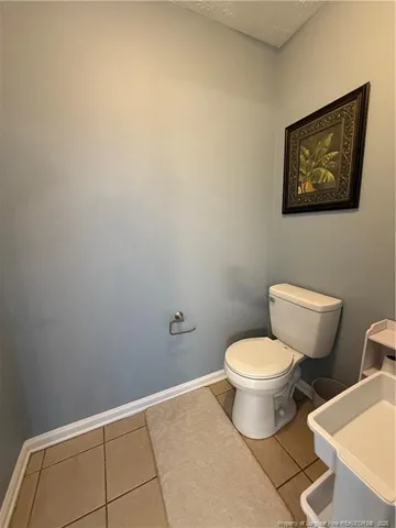 a white toilet sitting next to a white toilet