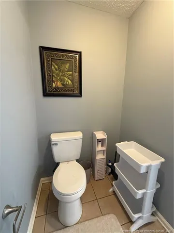 a bed room with a bed and a chair