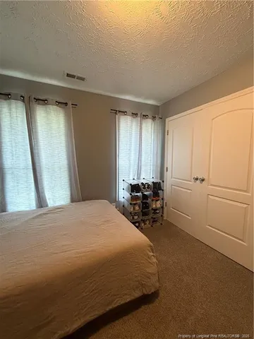 a bathroom with a double vanity sink toilet and a mirror