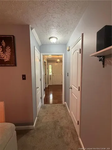 a view of a hallway with wooden shelves