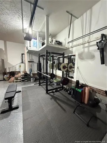 a view of a garage with cars and other equipment