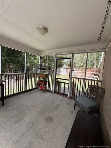 a view of a patio with table and chairs with wooden floor and fence